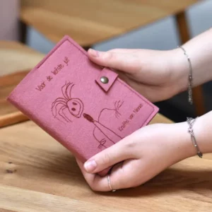 a person holding a pink wallet